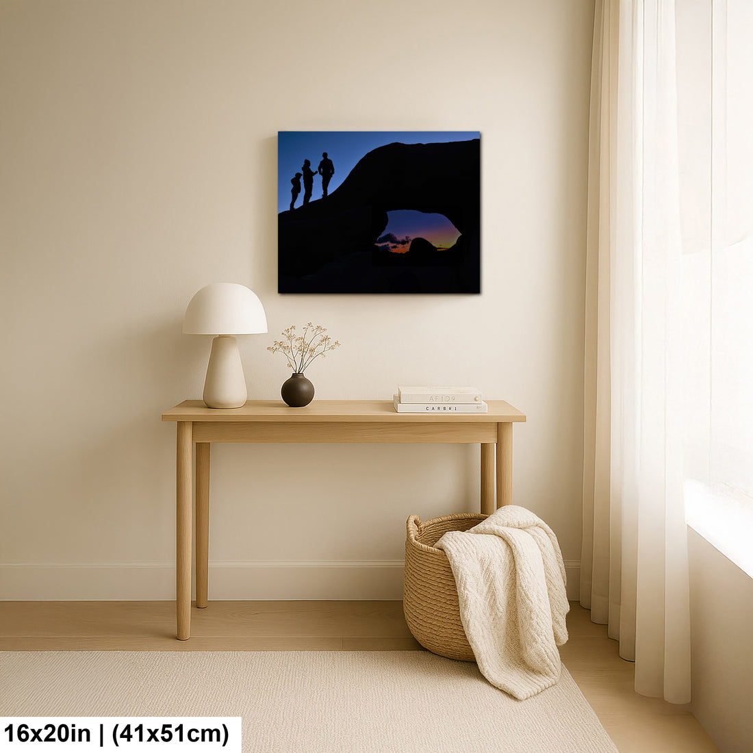 Silhouette of Arch Rock with silhoutte of people on top in Joshua Tree National Park