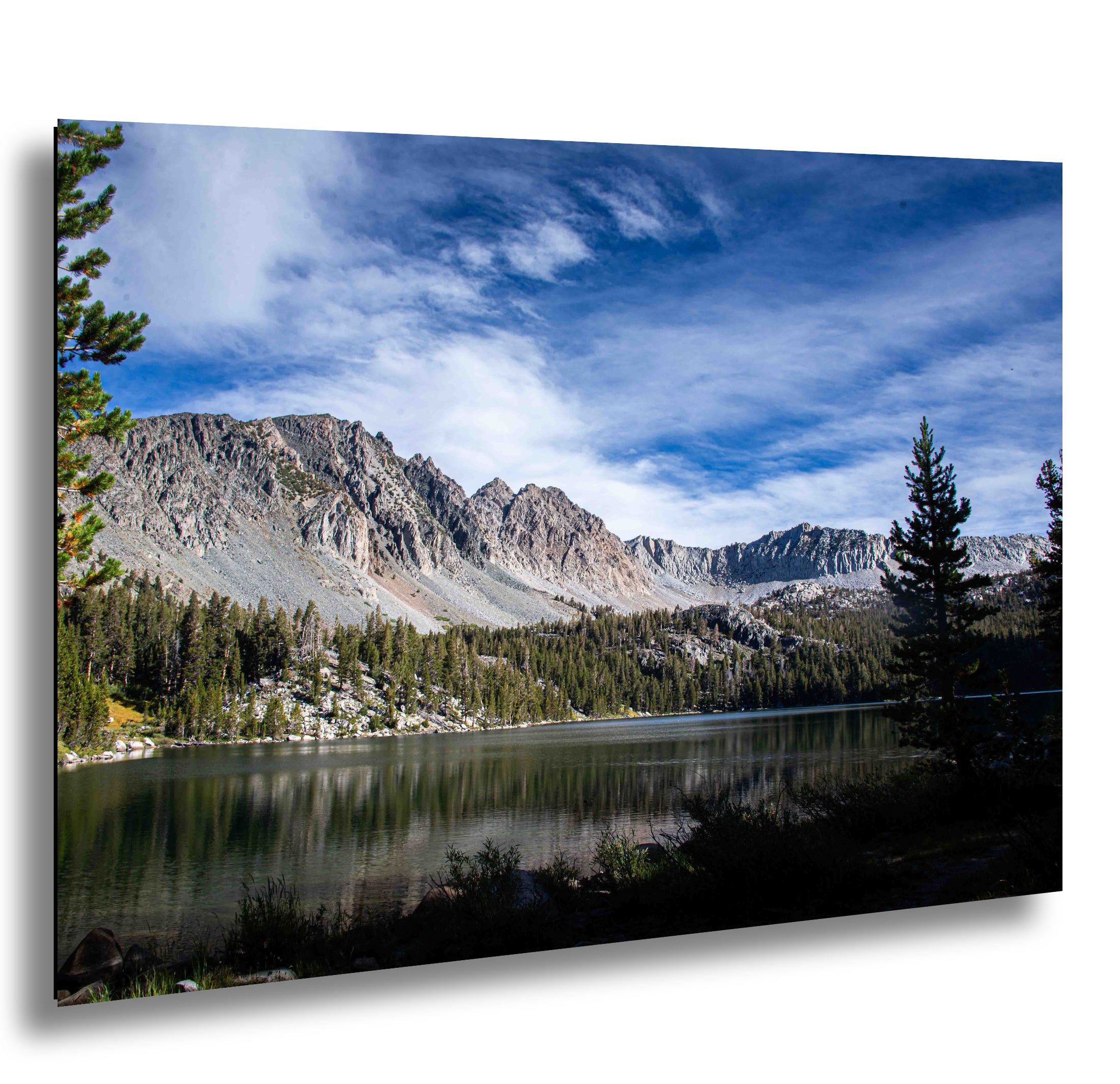 Death Valley sand dunes with dramatic storm clouds and mountain range in background.