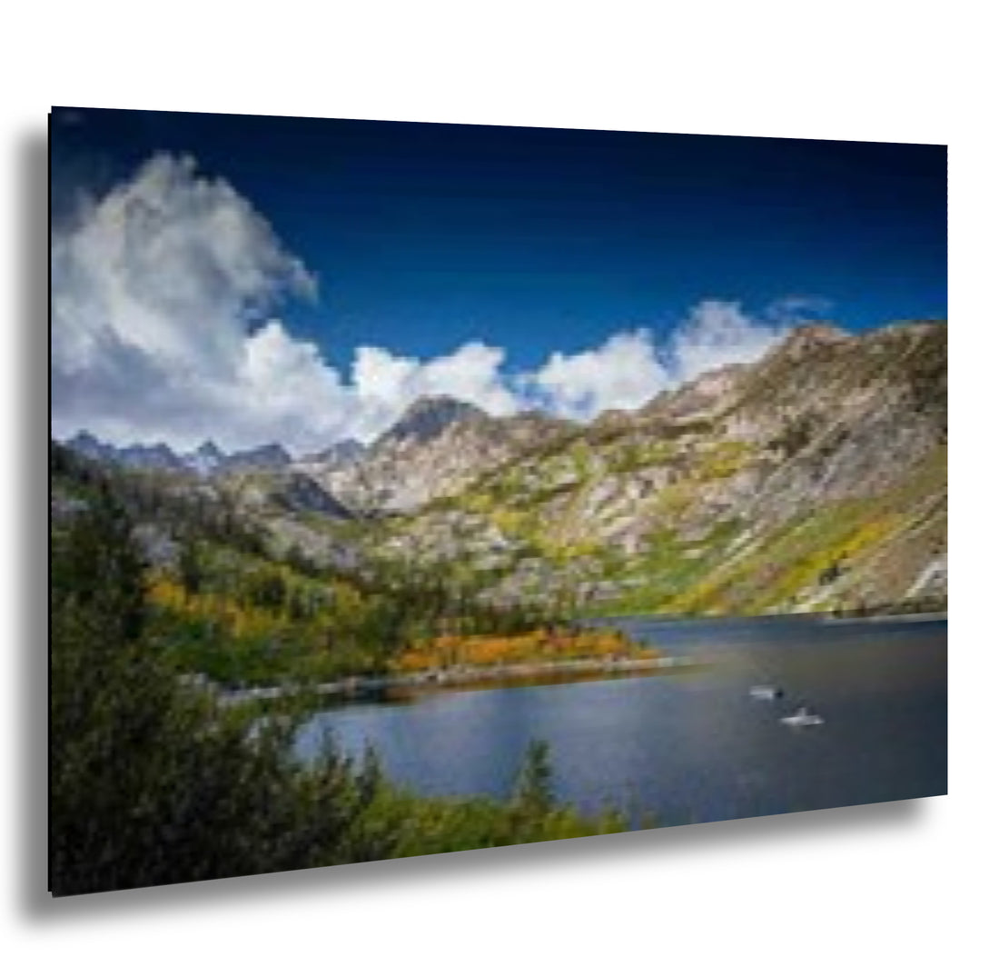Eastern Sierra alpine lake with mountain peaks, fall colors, and dramatic clouds.