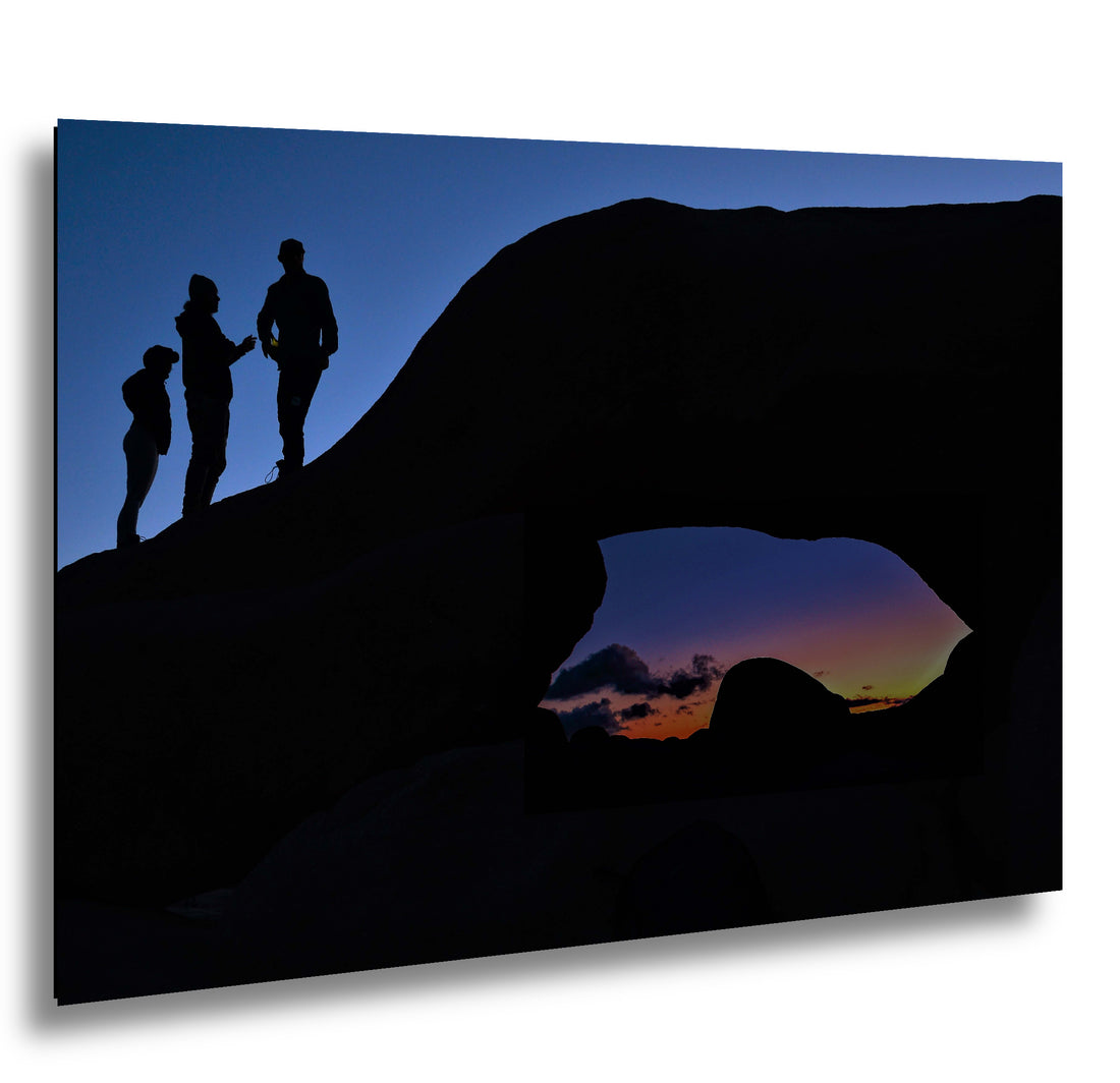 Silhouette of Arch Rock with silhoutte of people on top in Joshua Tree National Park
