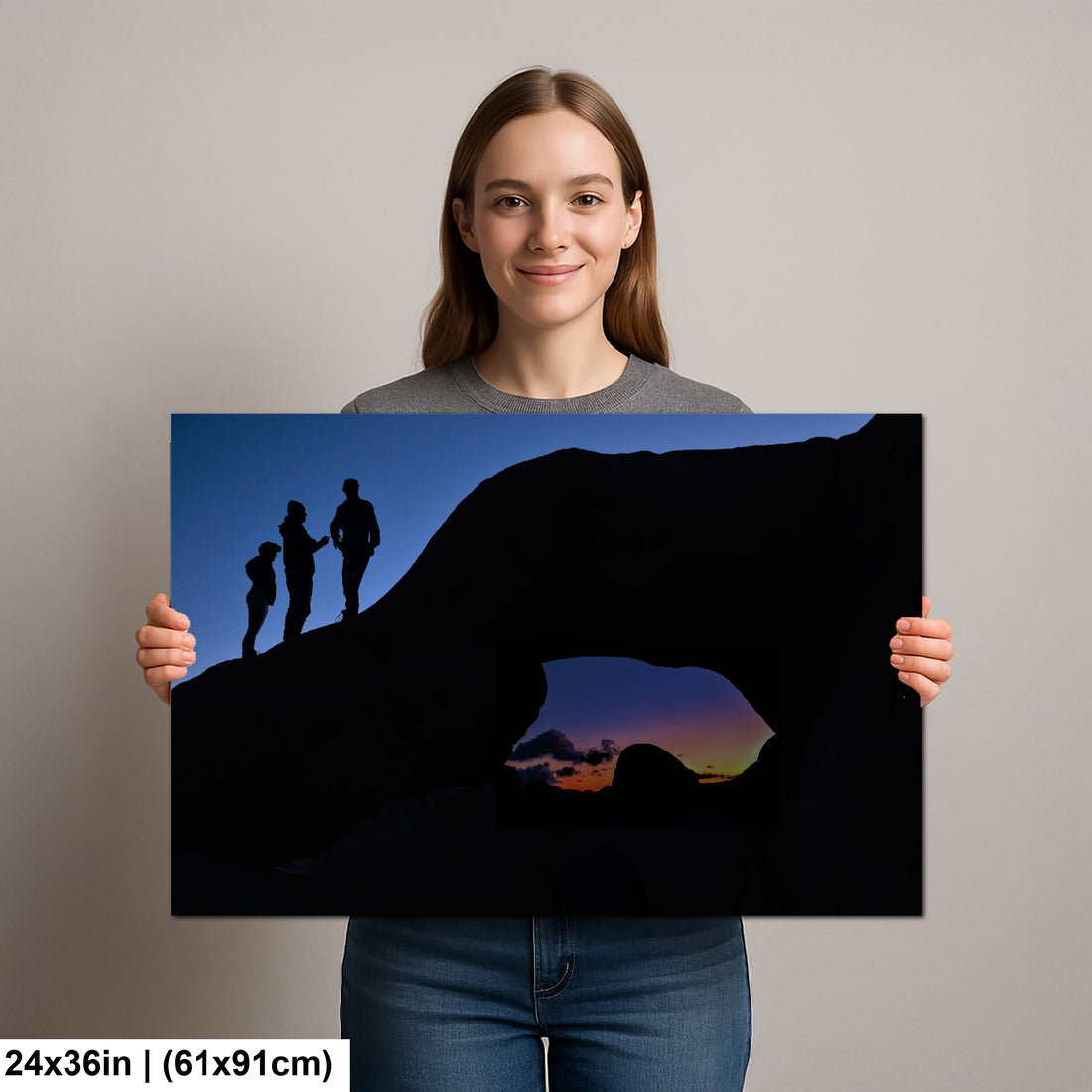 Silhouette of Arch Rock with silhoutte of people on top in Joshua Tree National Park