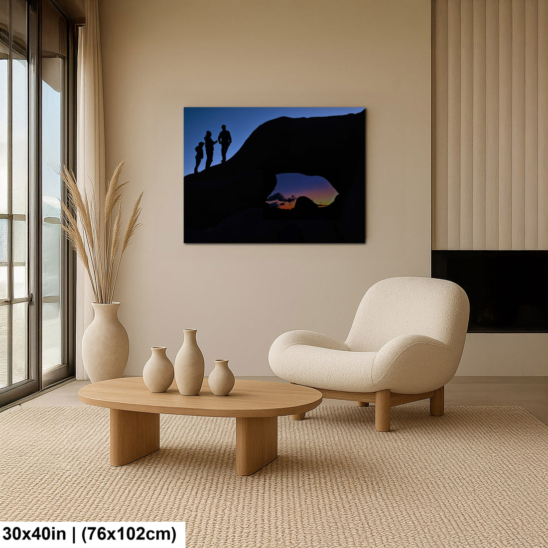 Silhouette of Arch Rock with silhoutte of people on top in Joshua Tree National Park