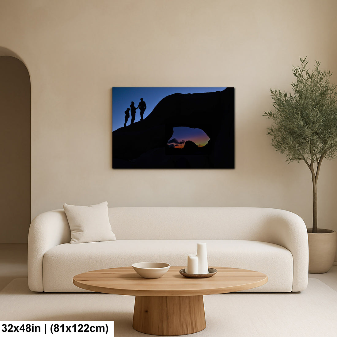 Silhouette of Arch Rock with silhoutte of people on top in Joshua Tree National Park