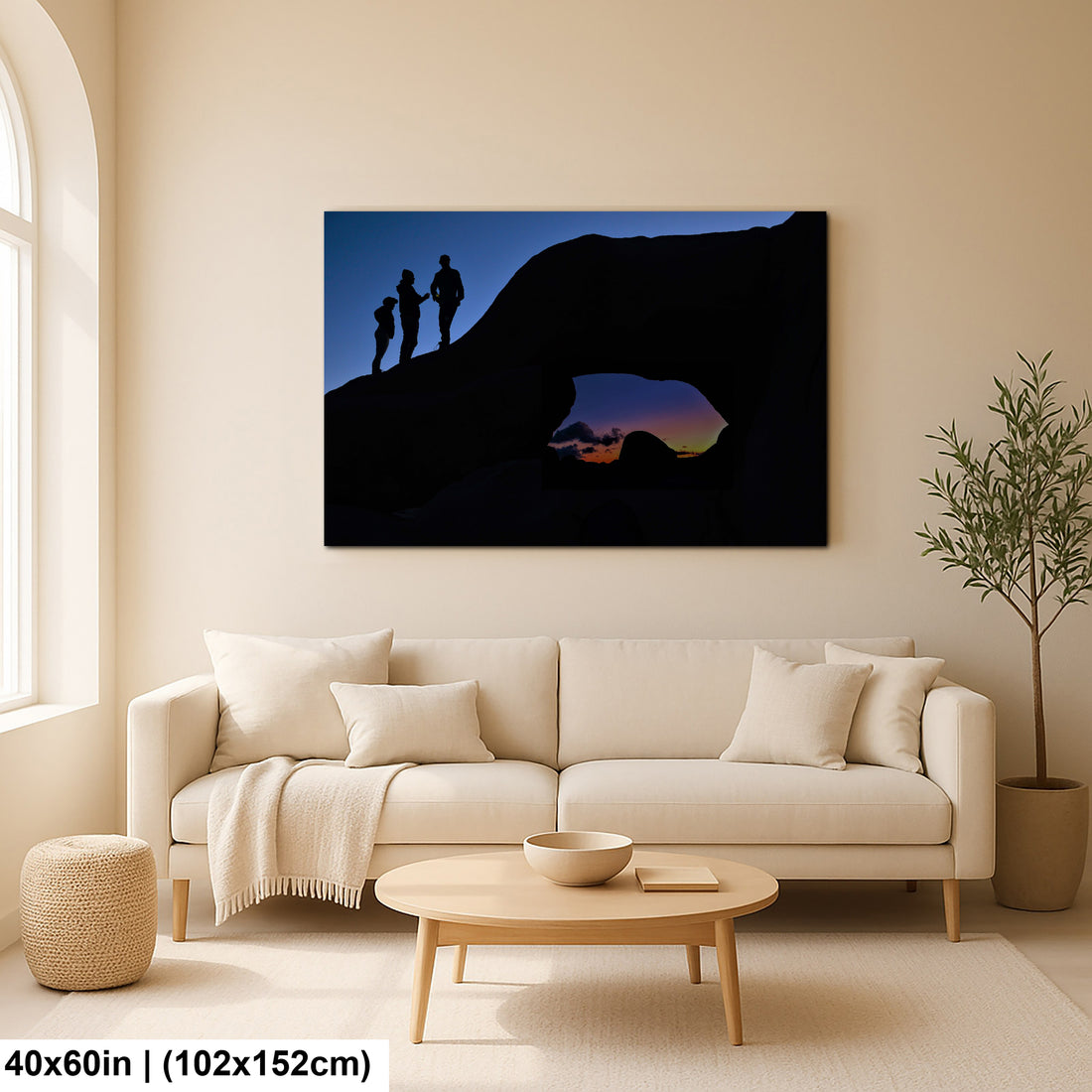 Silhouette of Arch Rock with silhoutte of people on top in Joshua Tree National Park