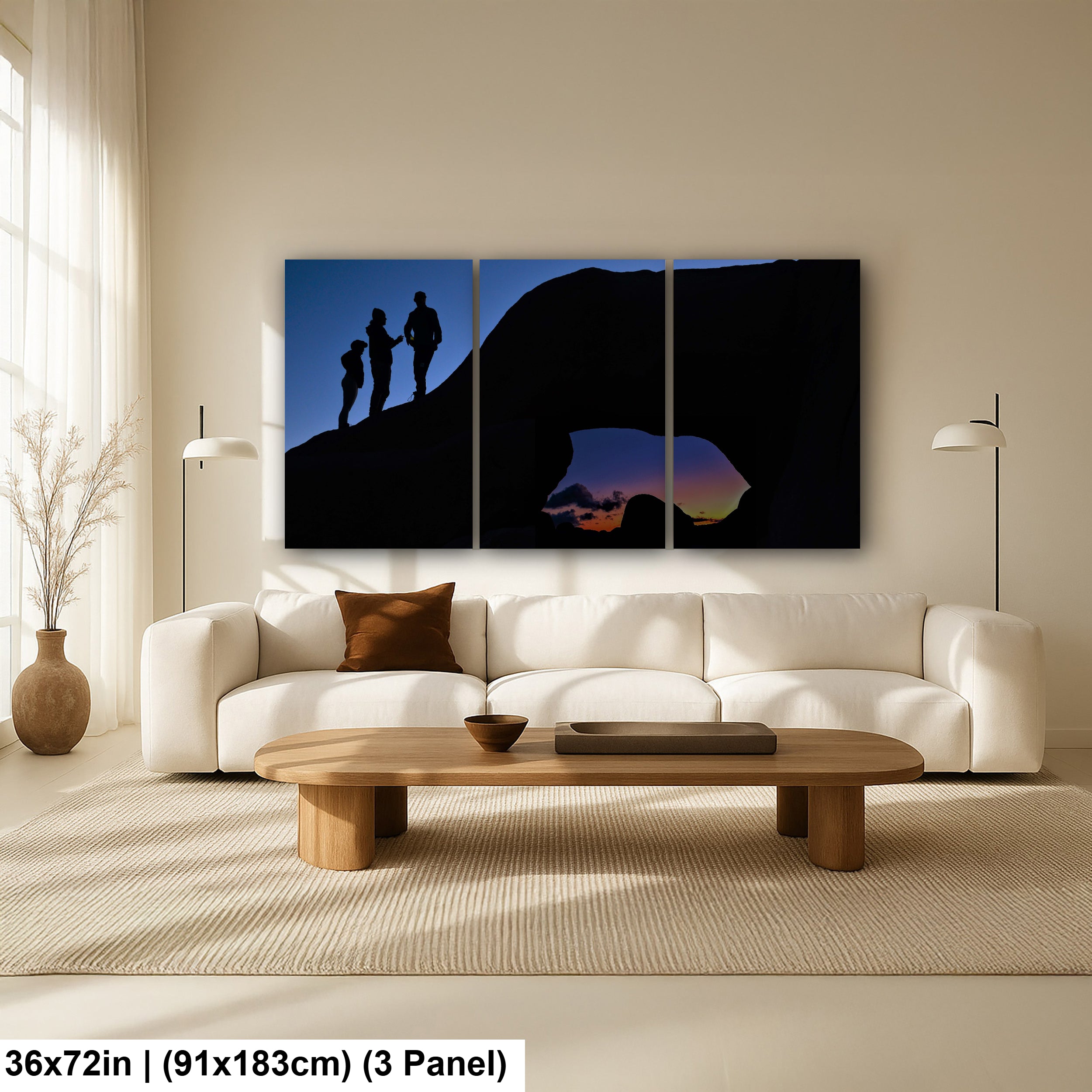 Silhouette of Arch Rock with silhoutte of people on top in Joshua Tree National Park