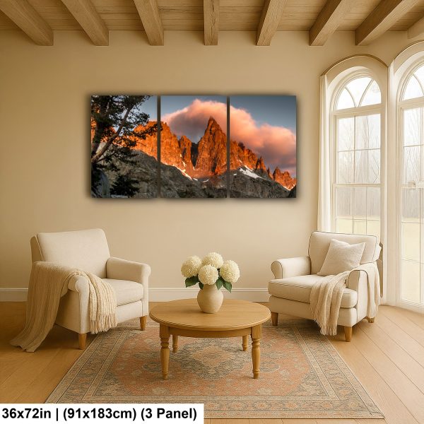 Mountain triptych artwork displayed above a coffee table in a cozy living room with natural light streaming through large windows.