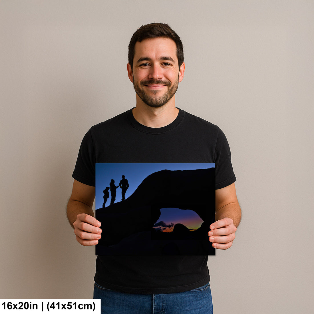 Silhouette of Arch Rock with silhoutte of people on top in Joshua Tree National Park